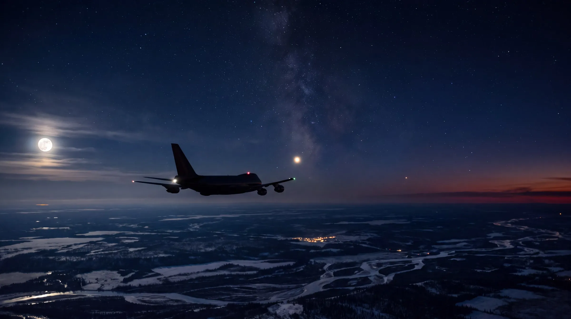 A night scene high over interior Alaska: a Boeing 747 freighter in the middle distance flies away toward the lower left, a dark silhouette picked out by its red and green navigation lights, over faint moonlit snow, spruce forest and braided river channels; low on the far left a nearly full moon glows through thin cloud; to the right of the aircraft, low above the horizon, hangs one brilliant golden point of light brighter than every star, with a second, fainter reddish point further right and slightly lower; a faint band of Milky Way climbs from behind the aircraft toward the top of the frame, and a deep-red afterglow stripe lies along the far right horizon; no text anywhere.