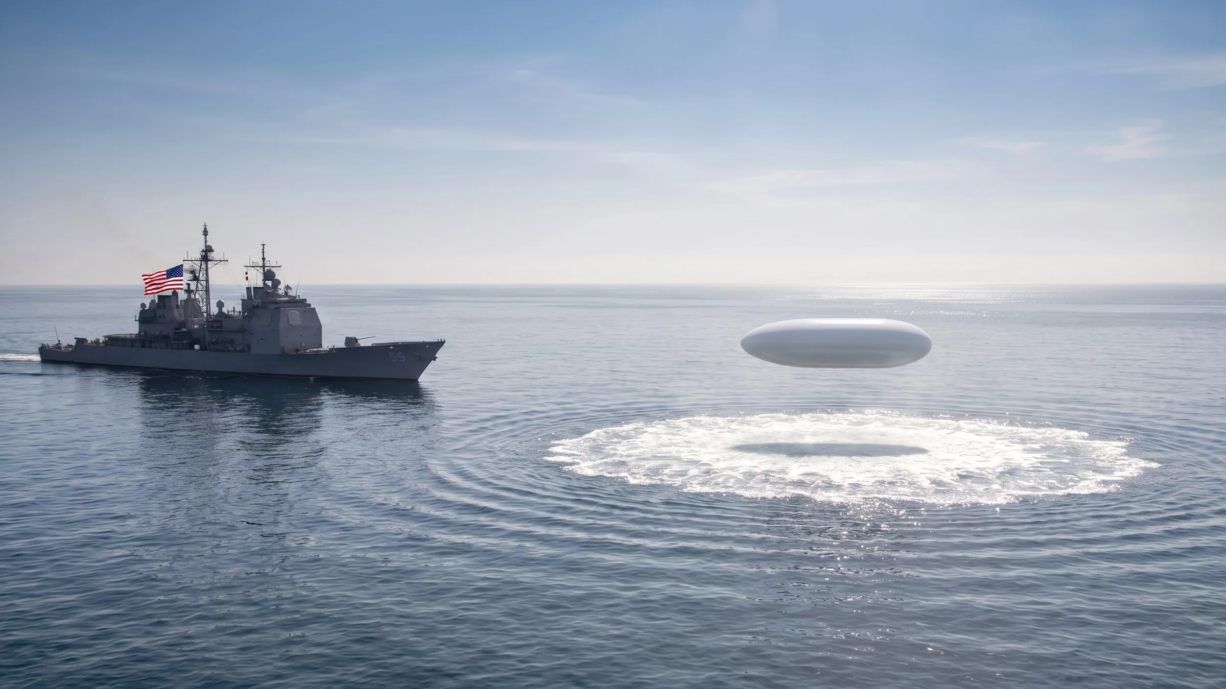 A grey US Navy guided-missile cruiser marked 59, flying the American flag from its mast, sailing at left on a calm hazy sea, while a smooth white capsule-shaped object hovers low over the water at right, above a wide ring of churned white foam, under a bright midday sky.